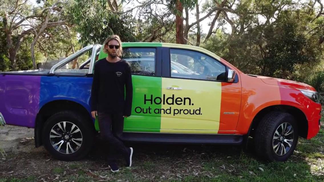 Wilko driving a rainbow car in Byron Bay